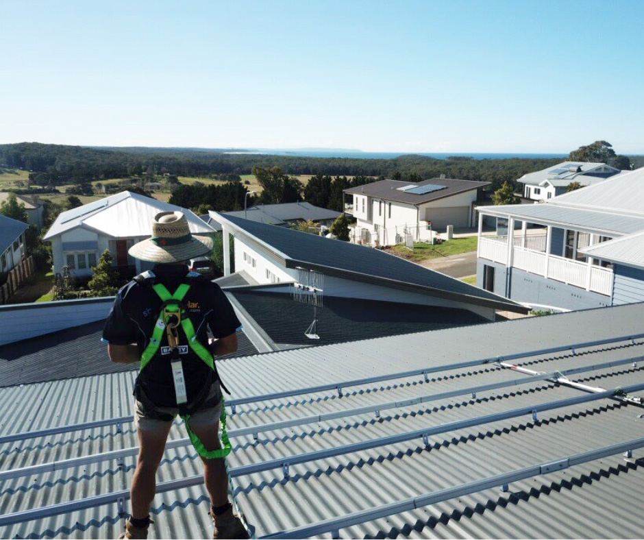 A solar installer enjoying the view from a rooftop