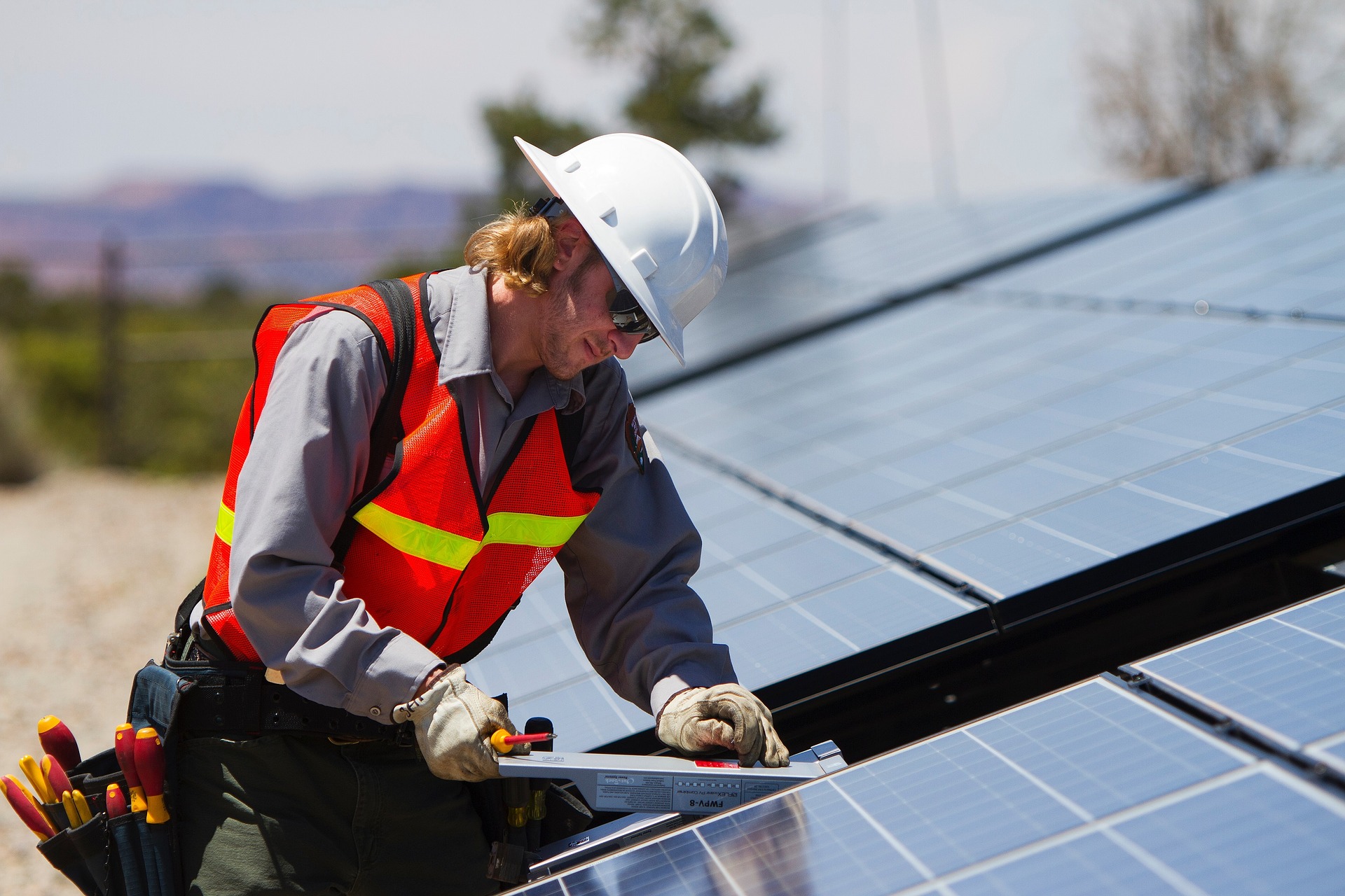 Solar panel installer at work on a roof