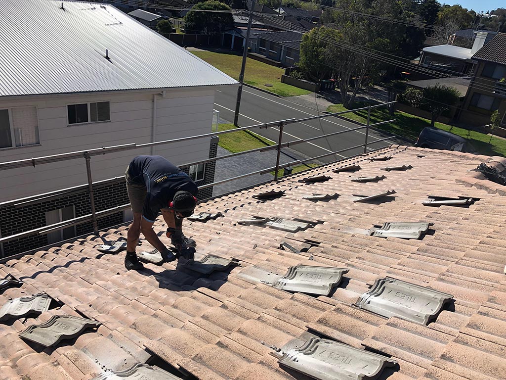 Darren grinding tiles to avoid the solar panels causing leaks in a tile roof